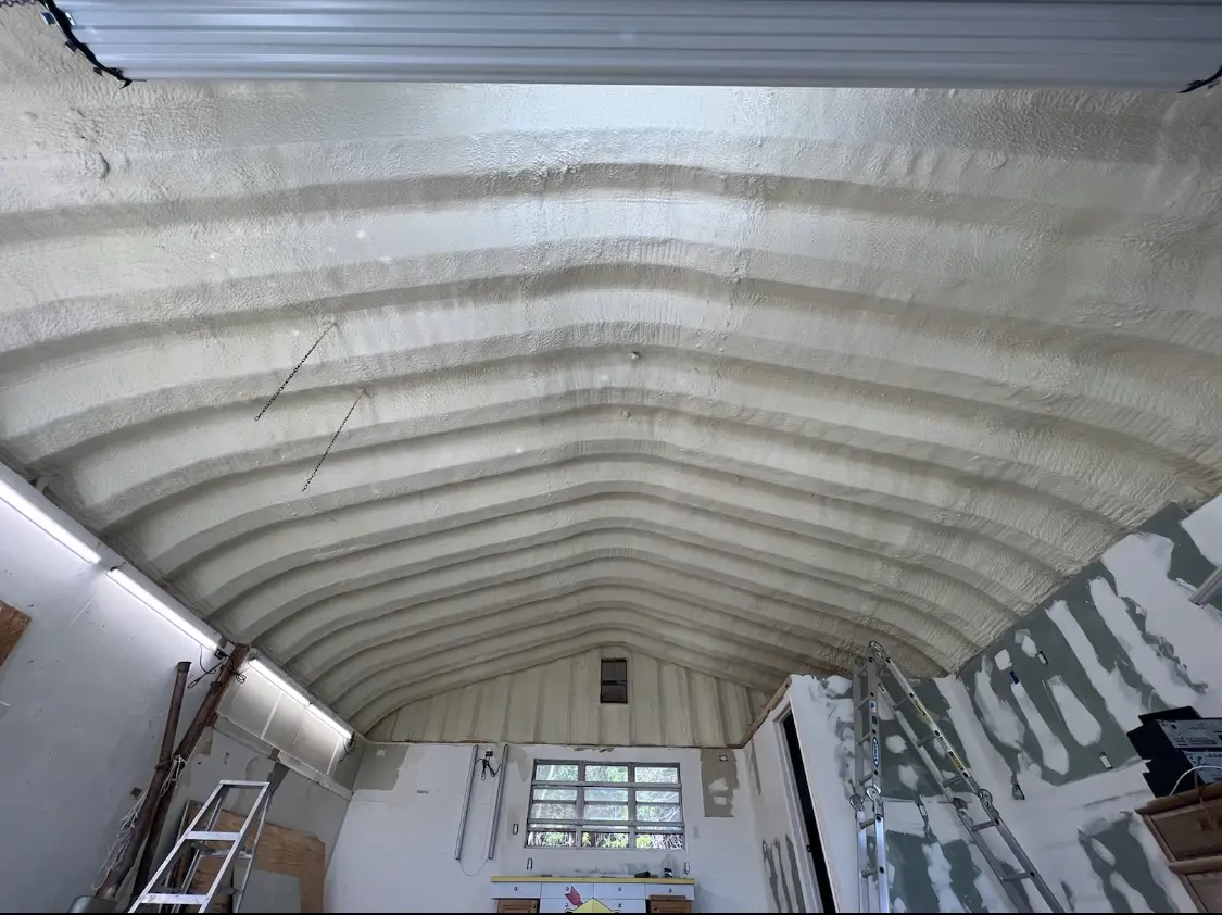 Spray polyurethane foam applied to the underside of a metal roof deck in Siler City